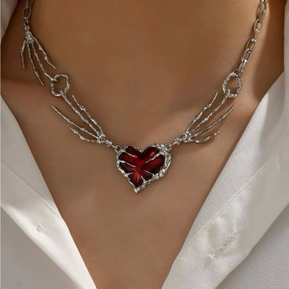 Awesome silver skeleton hands and red heart ! New